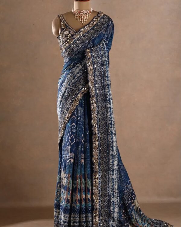 The deep blue base is beautifully enhanced with intricate printed motifs, ornate borders and rich metallic embellishments.