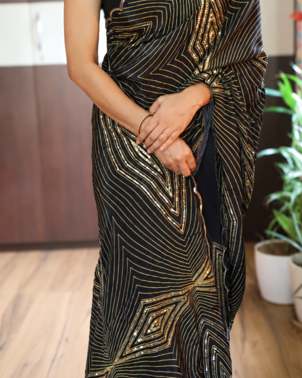 Black pure crepe silk cocktail saree with gold zari geometric patterns and handwork sequins