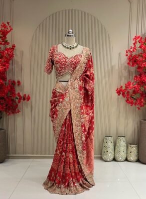Red embellished party wear saree with gold tone scalloped floral border
