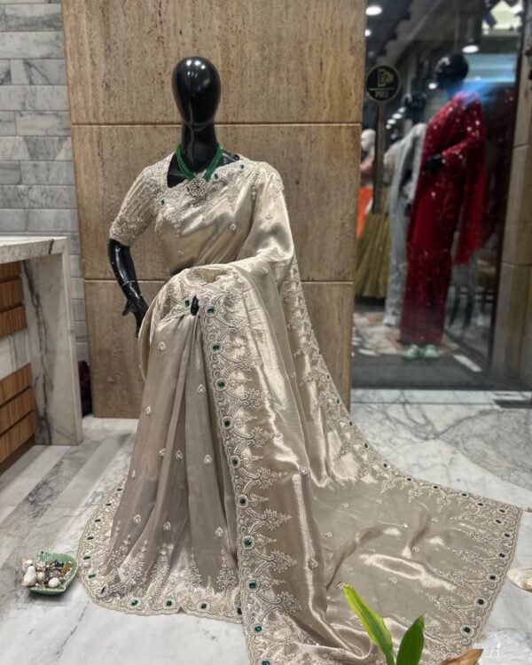 Ivory embellished party wear saree with silver-tone scalloped border and green stones, full drape