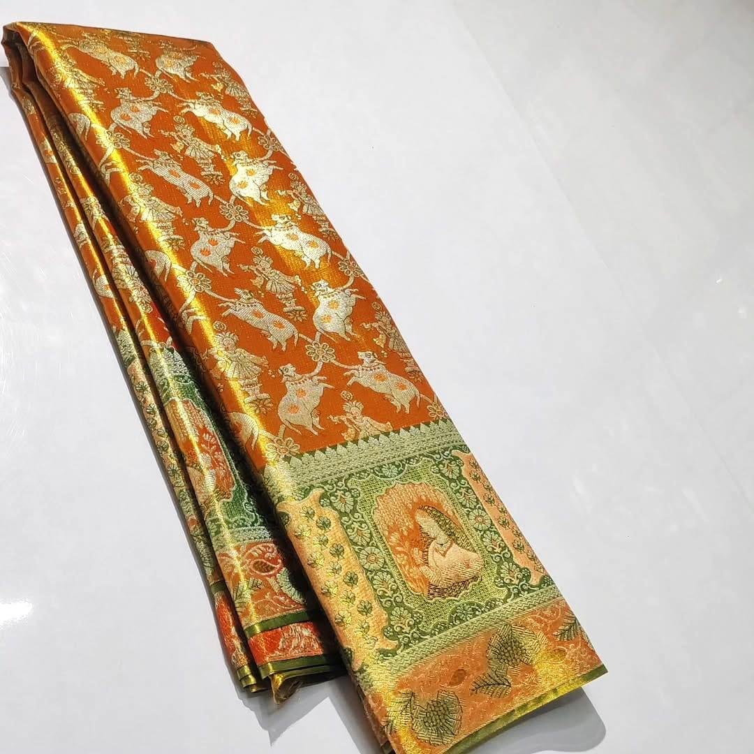 Pure Kanchipattu Tissue Meenakari Brocade Saree – Orange and Green 1 Pure Kanchipattu tissue orange and green meenakari brocade saree folded view