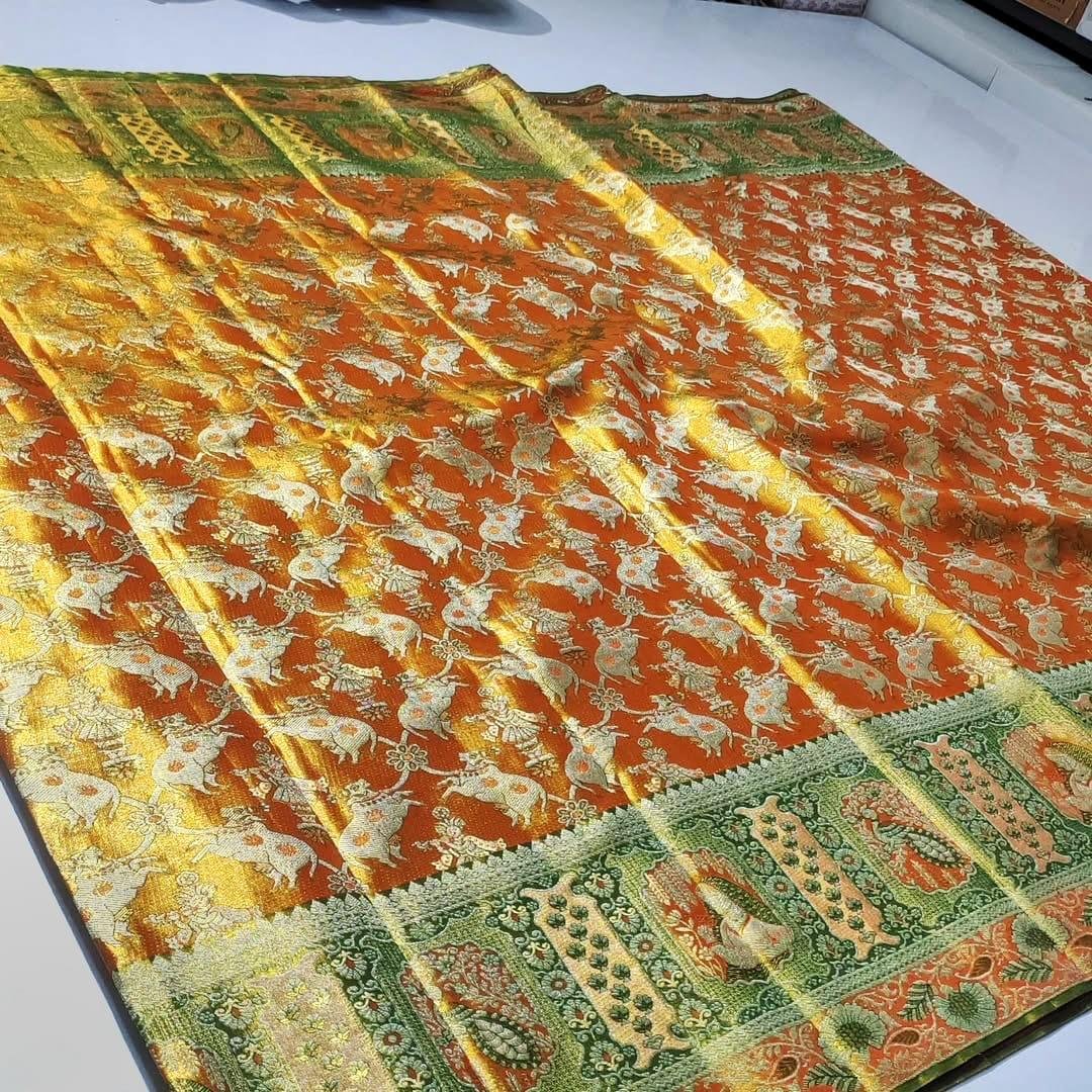 Pure Kanchipattu Tissue Meenakari Brocade Saree – Orange and Green 2 Pure Kanchipattu tissue orange body with cow meenakari motifs and green ornamental border