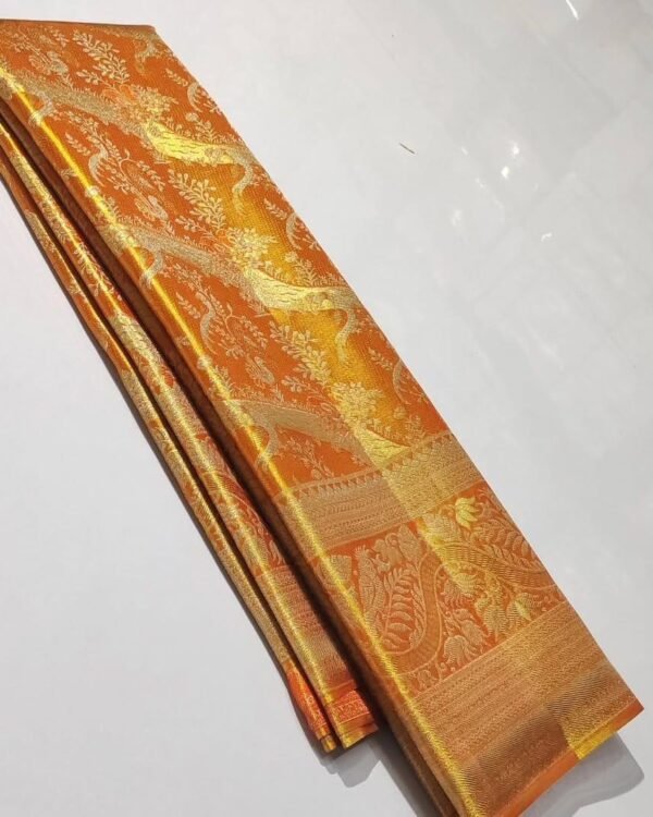 Pure Kanchipattu tissue orange saree with silver and gold zari brocade in folded view