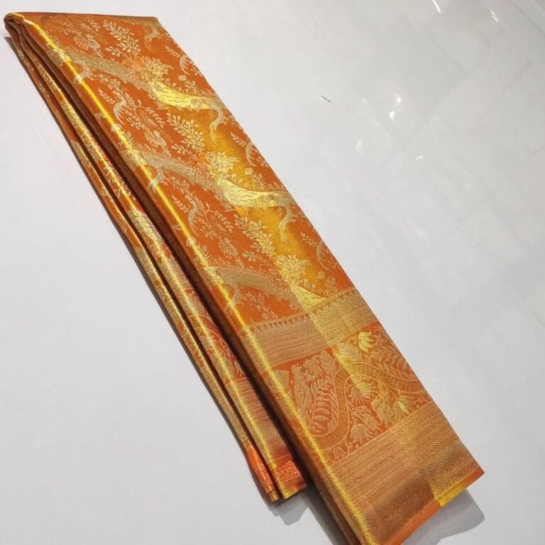 Pure Kanchipattu tissue orange saree with silver and gold zari brocade in folded view