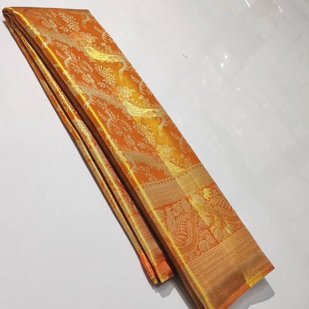 Pure Kanchipattu Tissue Silver and Gold Zari Brocade Saree – Orange 1 Pure Kanchipattu tissue orange saree with silver and gold zari brocade in folded view