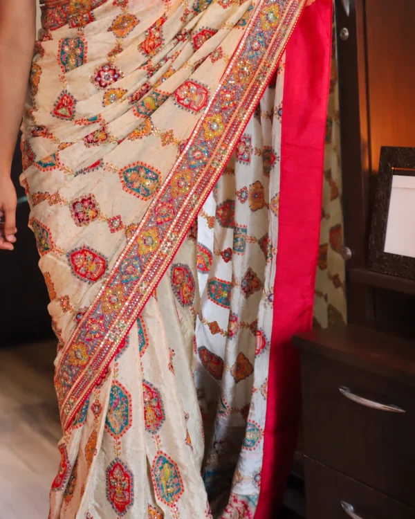 Cream designer crepe satin saree with Aari work and multicolour Rajasthani patchwork