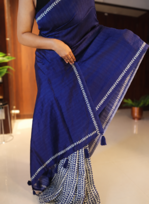 Handpainted Tussar silk saree in navy blue and cream with leaf motifs and tasselled pallu