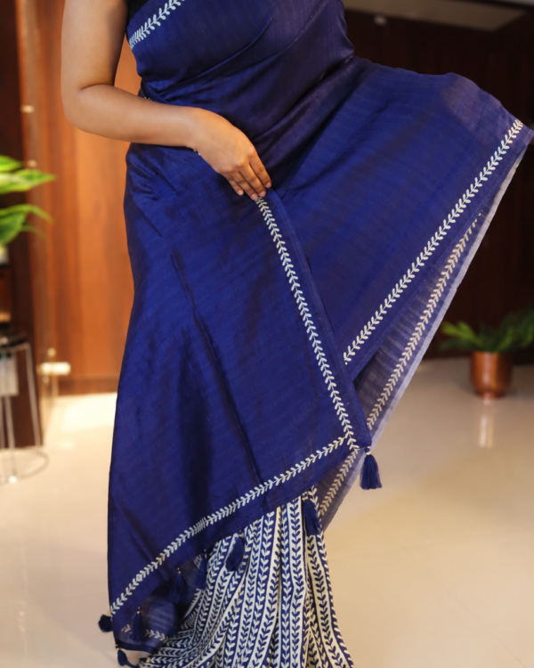 Handpainted Tussar silk saree in navy blue and cream with leaf motifs and tasselled pallu