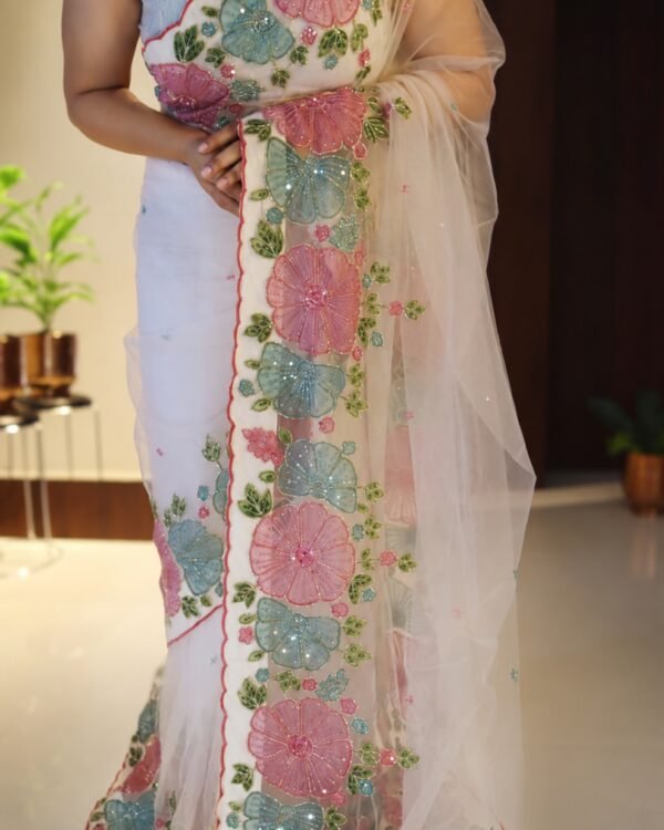 Off white pure net handwork saree with pink and aqua floral applique, full drape