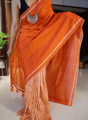 Orange handpainted Tussar silk saree with cream leaf motifs and tasselled pallu
